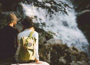 Backpacker overlooking a scenic waterfall near Nelson BC